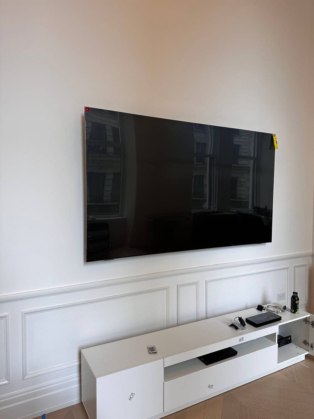 TV mounted on a plaster wall in a pre-war Manhattan apartment